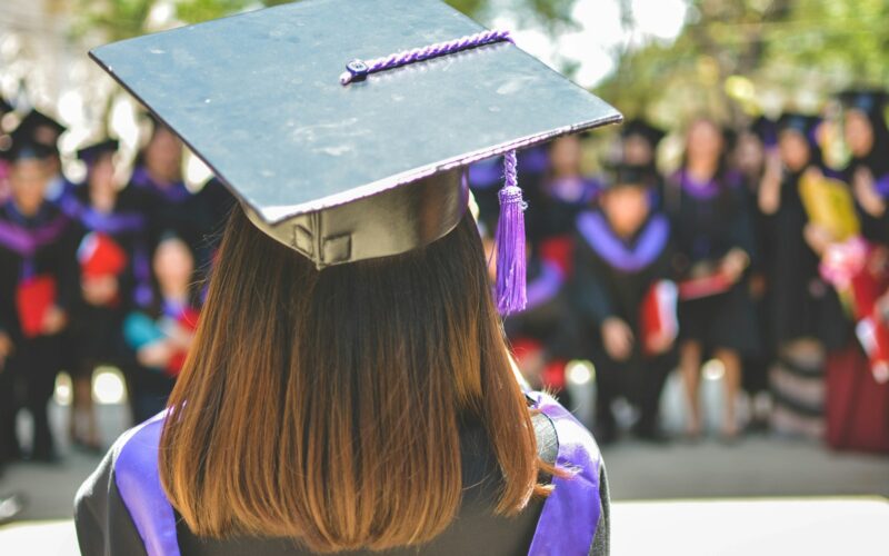 woman wearing academic cap and dress selective focus photography