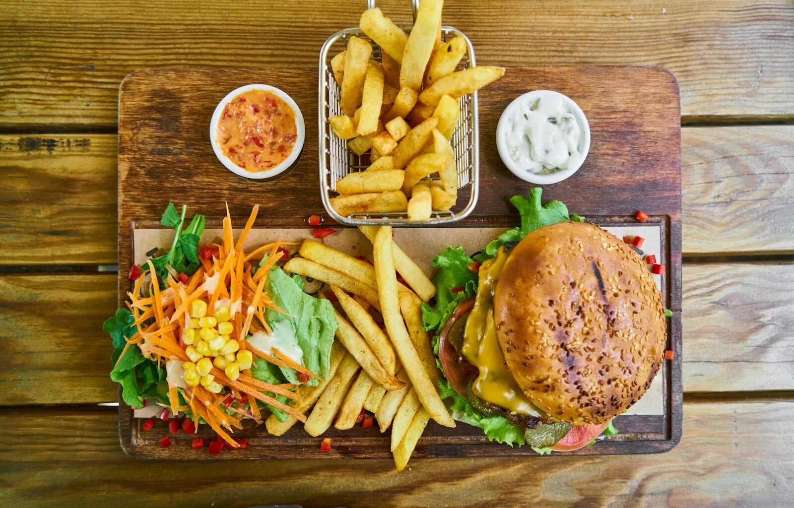 fries and burger on brown wooden tray