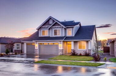 Elegant suburban home with driveway at sunset showcasing modern architecture.