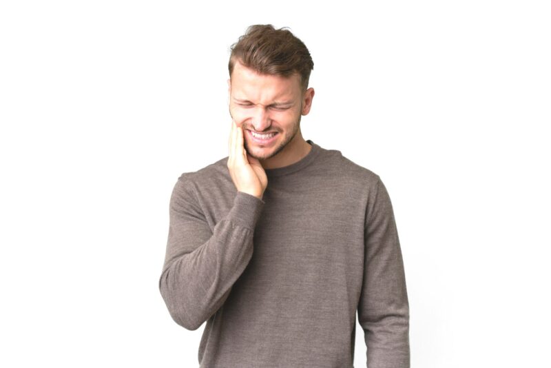 young handsome caucasian man isolated white background with toothachecopy
