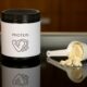 a container of protein powder next to a spoon