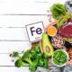 food containing natural iron fe liver avocado broccoli spinach parsley beans nuts white wooden background top view wp