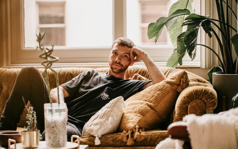 a man sitting on a couch in a living room
