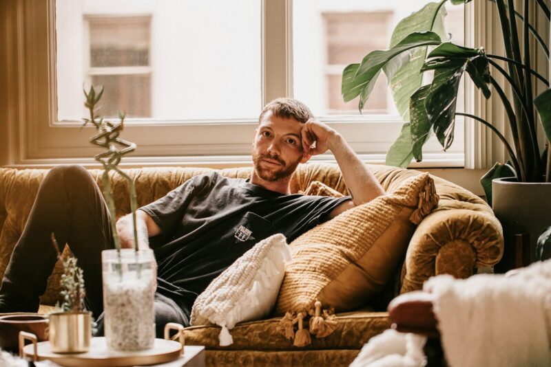 a man sitting on a couch in a living room